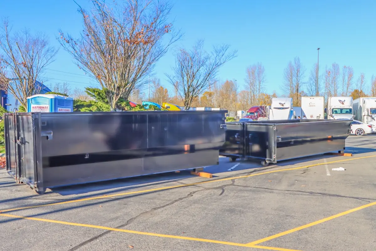 Professional dumpster rental service with roll-off container on residential driveway in La Riviera